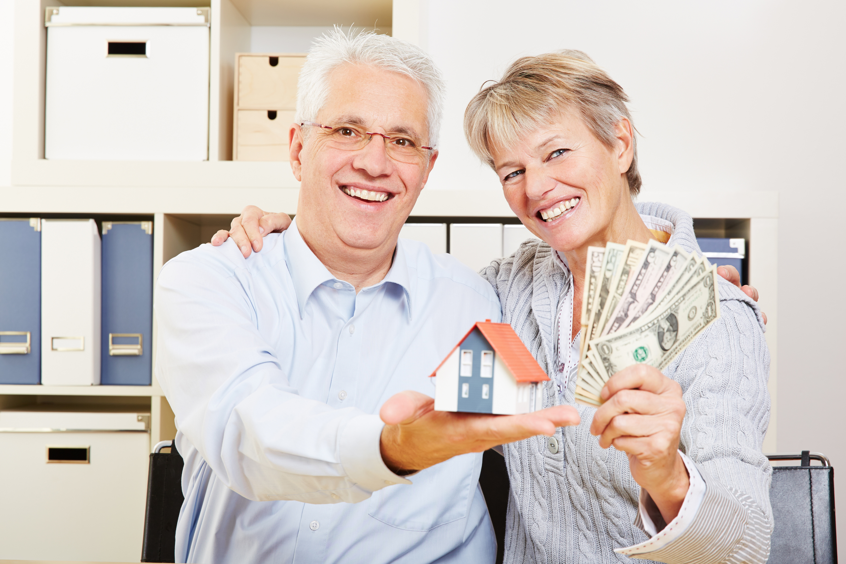 graphic of hand holding miniature house