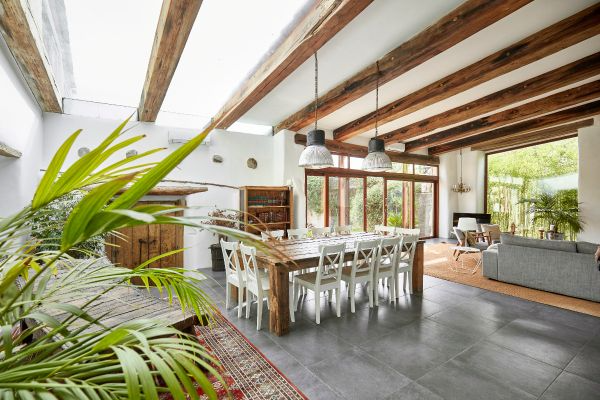 large family room beside patio with tile floors and wide table