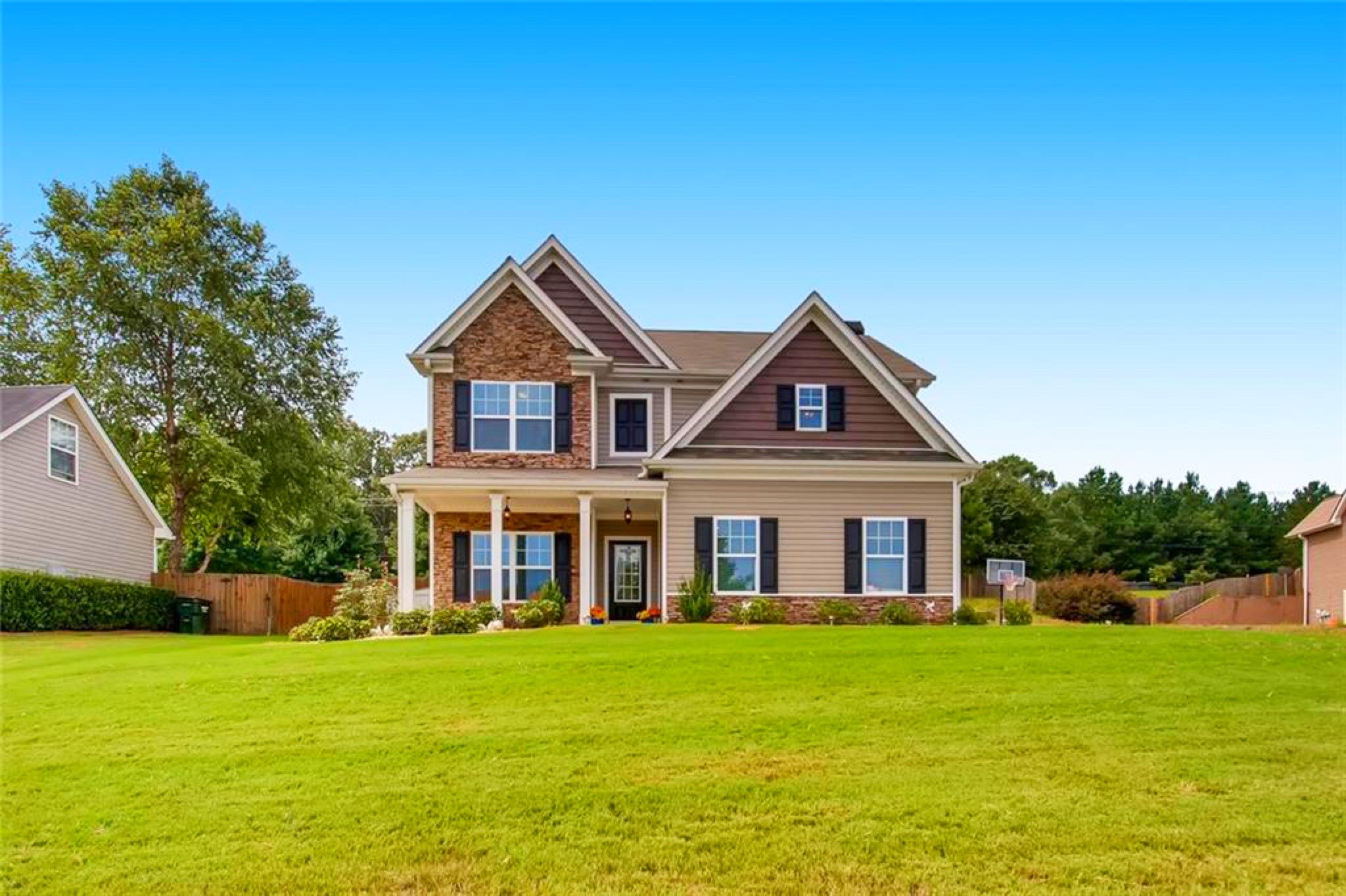 outdoor patio with blue couch and hanging lights