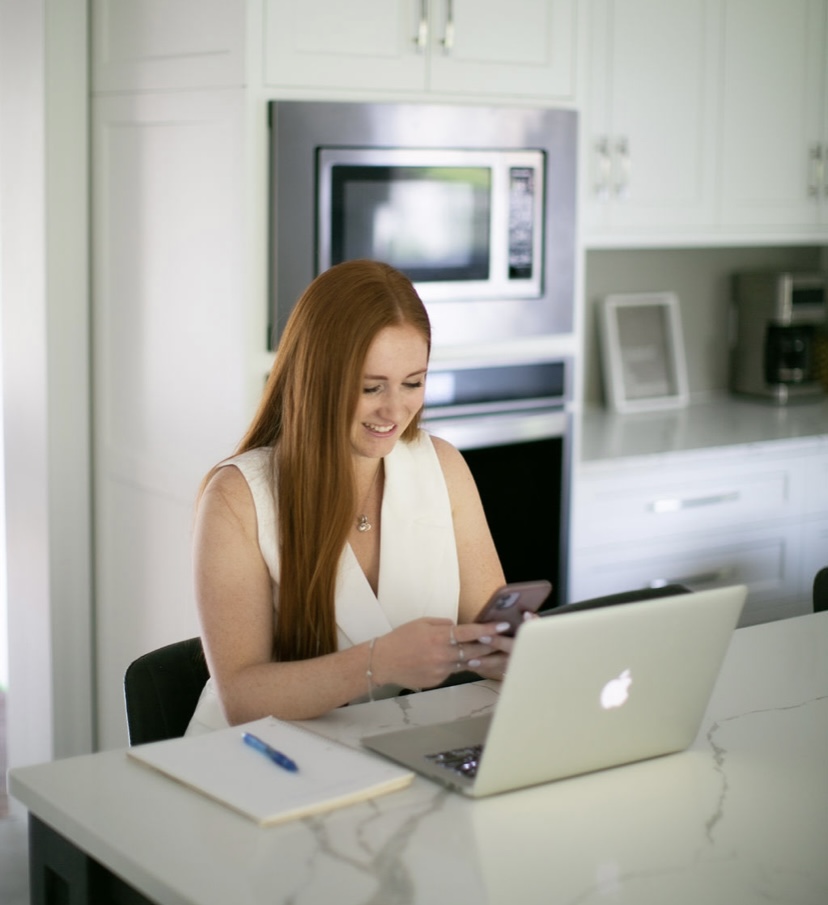 man and woman smiling looking at phone
