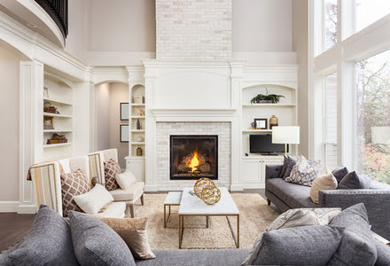 small living room with brick walls and shelves beside two chairs