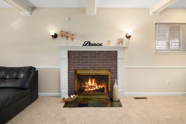 living room with fireplace and large overhead shelf 
