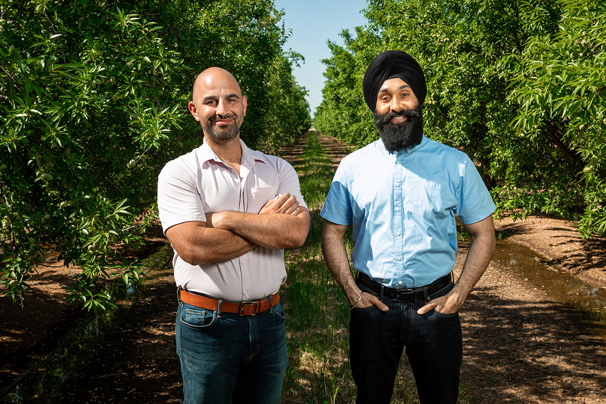 J.P. Shamshoian and Paul Bal standing in an orchard