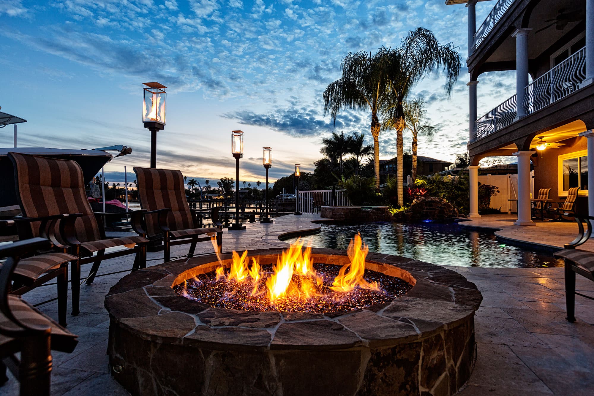 outdoor patio with blue couch and hanging lights