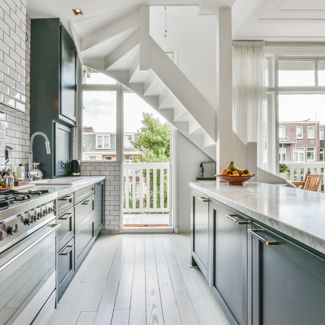 kitchen counter island with white cabinets and wood floors