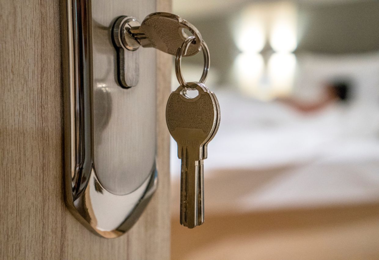 graphic of hand holding miniature house