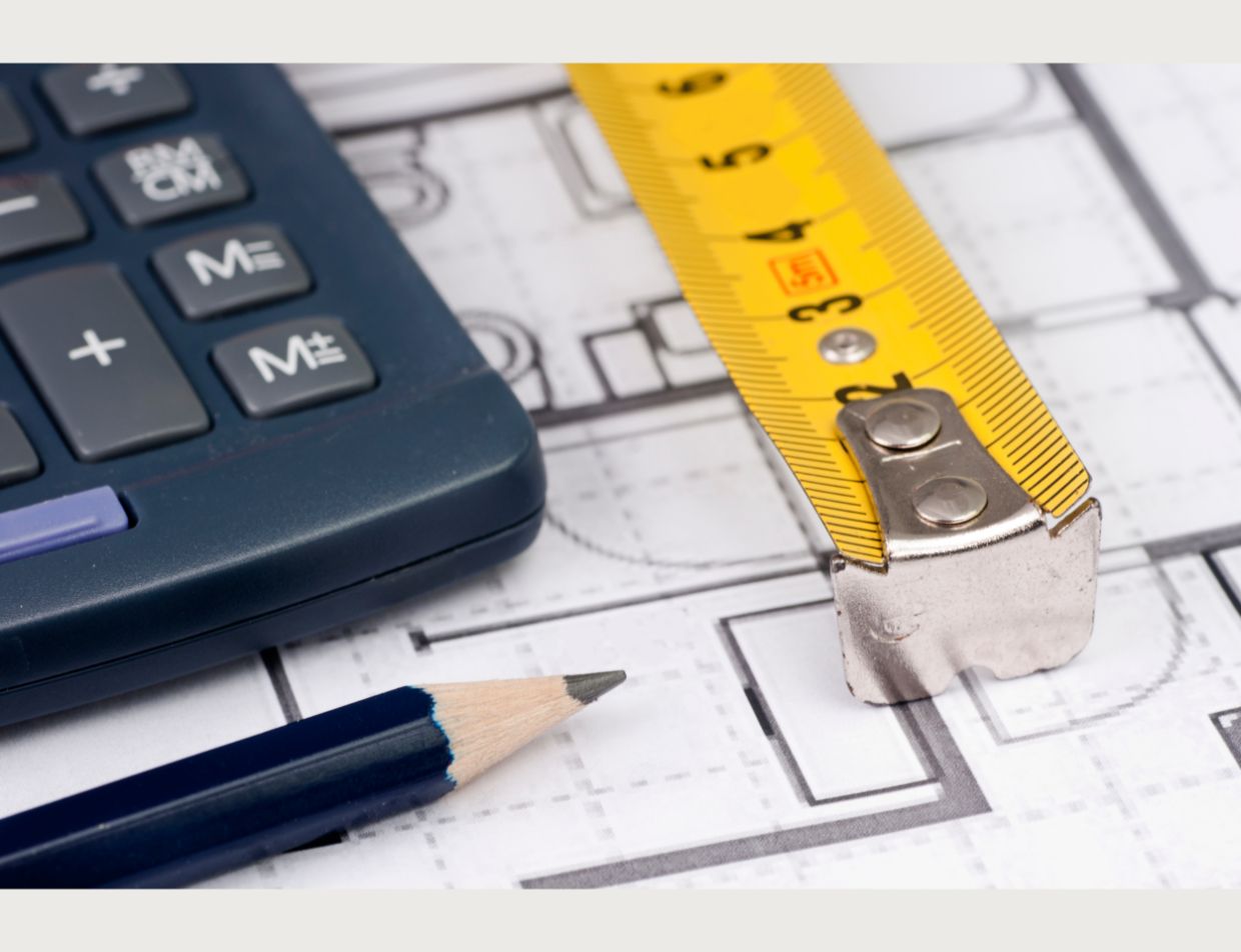 small house on keychain laying beside calculator