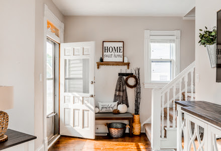 kitchen counter island with white cabinets and wood floors