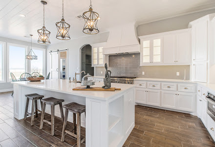 large living room with wood floors and steps to kitchen